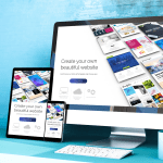 A desktop computer monitor, tablet, and smartphone displaying a responsive website builder interface on a light blue desk.